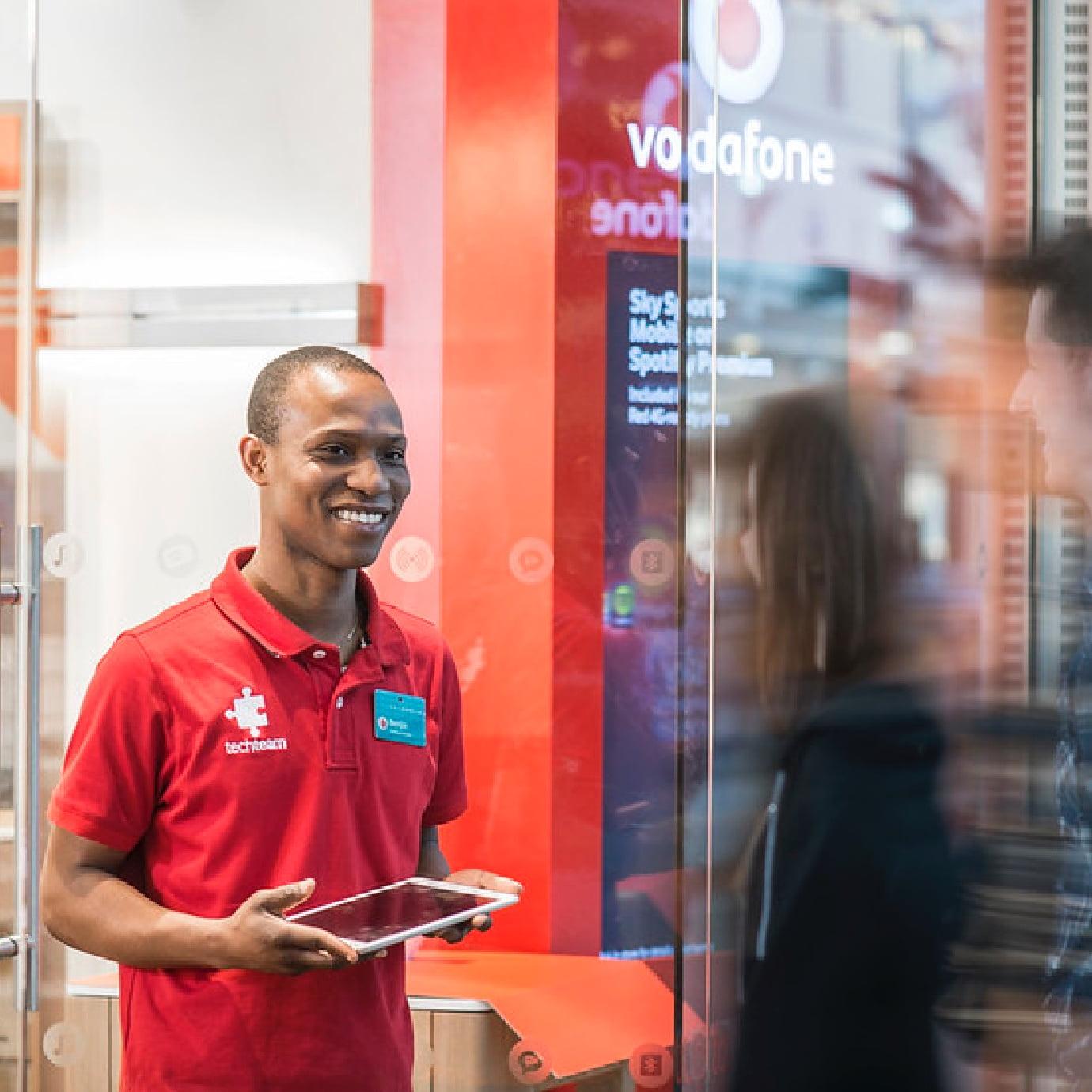 vodafone Employee smiling with tablet