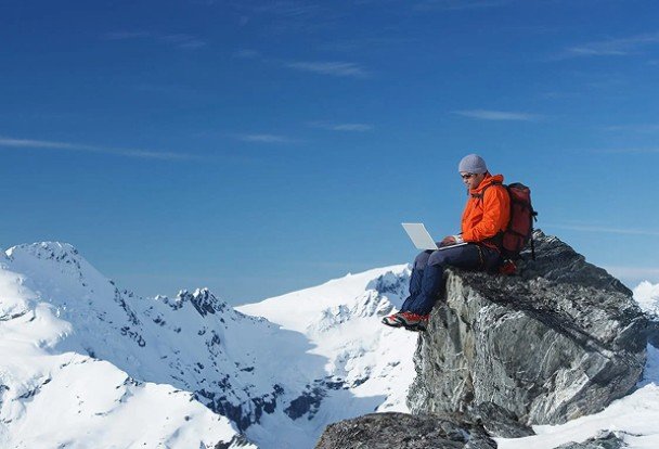 Man on mountain with laptop